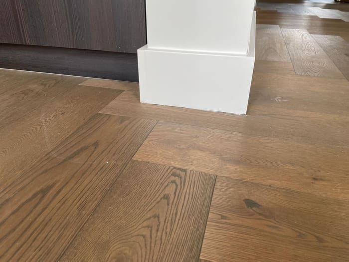 Wood floor, skirting board detail, chevron parquet, Den Haag