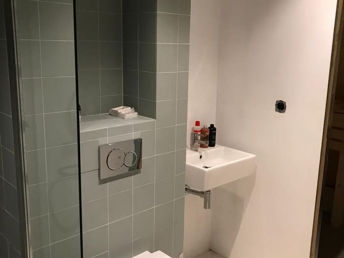 Toilet with grey tiling